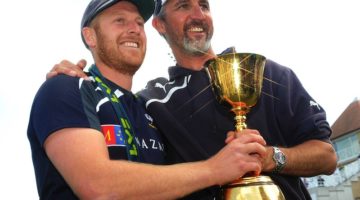 jason gillespie and andrew gale hold the championship trophy