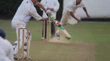 club cricket bowler beats the bat