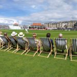 fans sit in deckchairs at scarborough cricket club