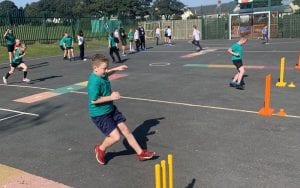 schoolchildren play cricket in the playground
