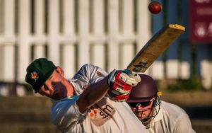 front image up close of batter in the evening light hitting out